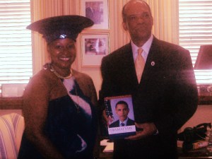 Premier_Dr._Ewart_Brown_receiving_Obamatyme_from_Poet_Melodye_Micere_VanPutten